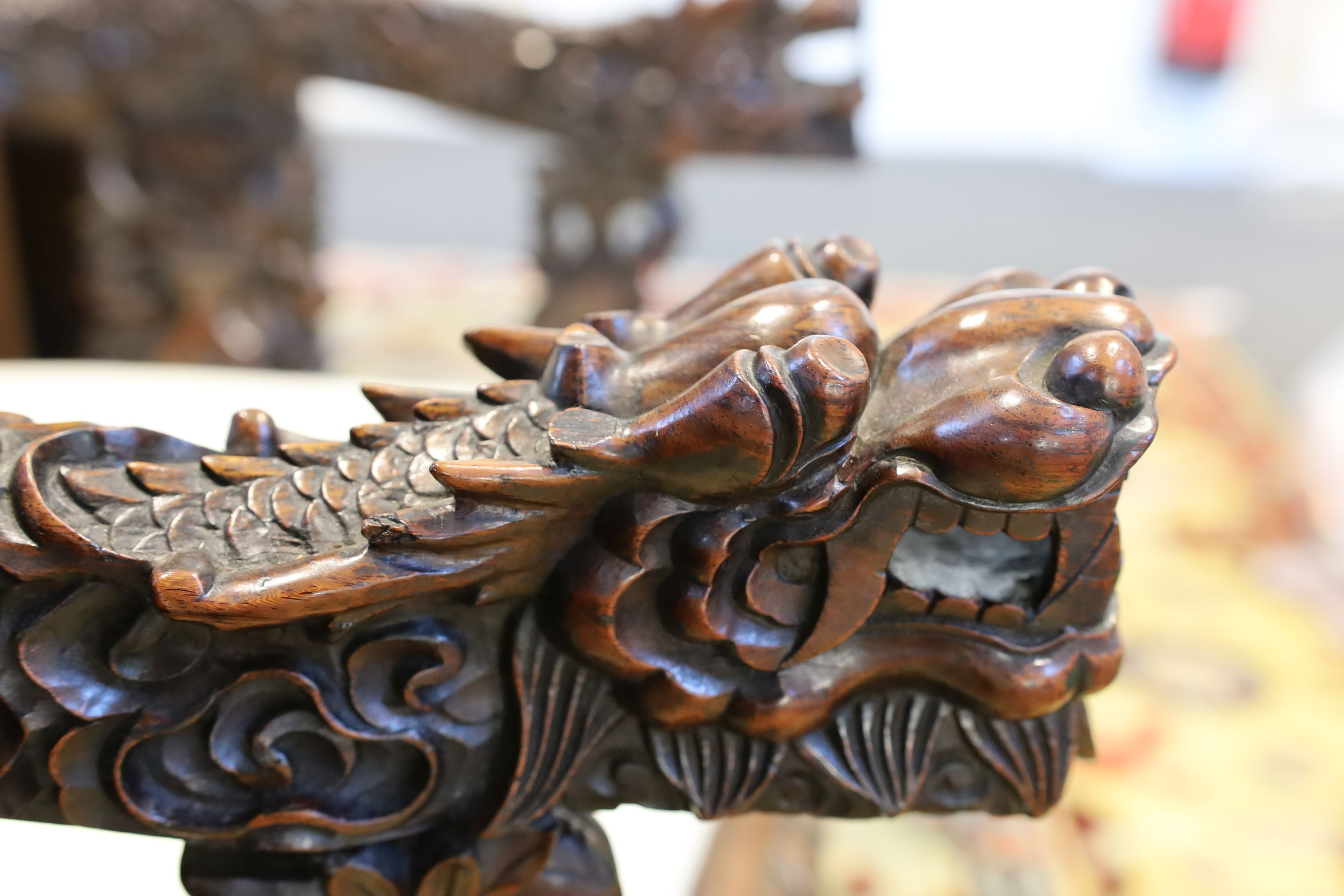 A good Chinese hardwood ‘dragon’ throne armchair, c.1900, 114.5cm high, 68cm wide at the arms